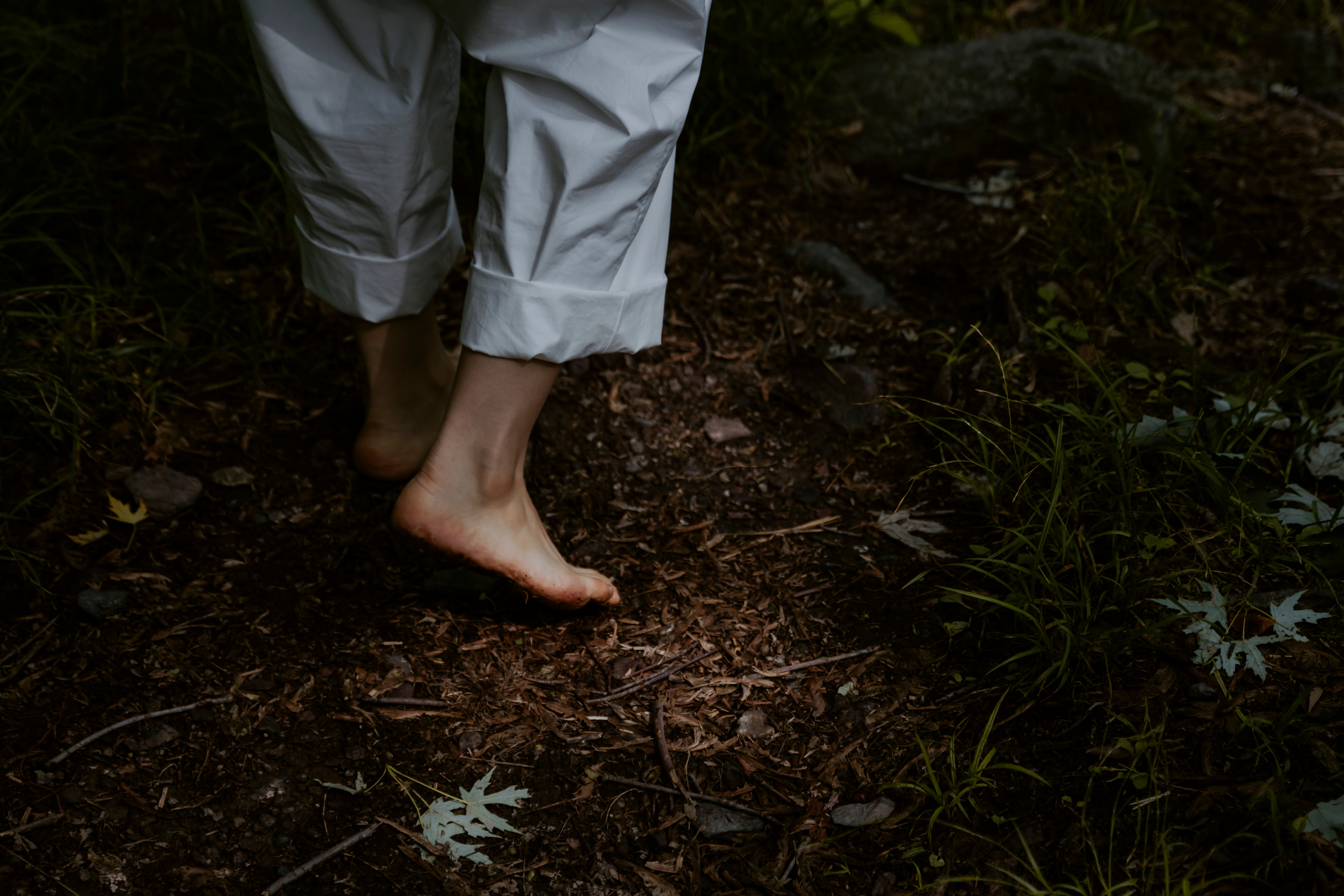 Woman Walking Barefoot in Forest