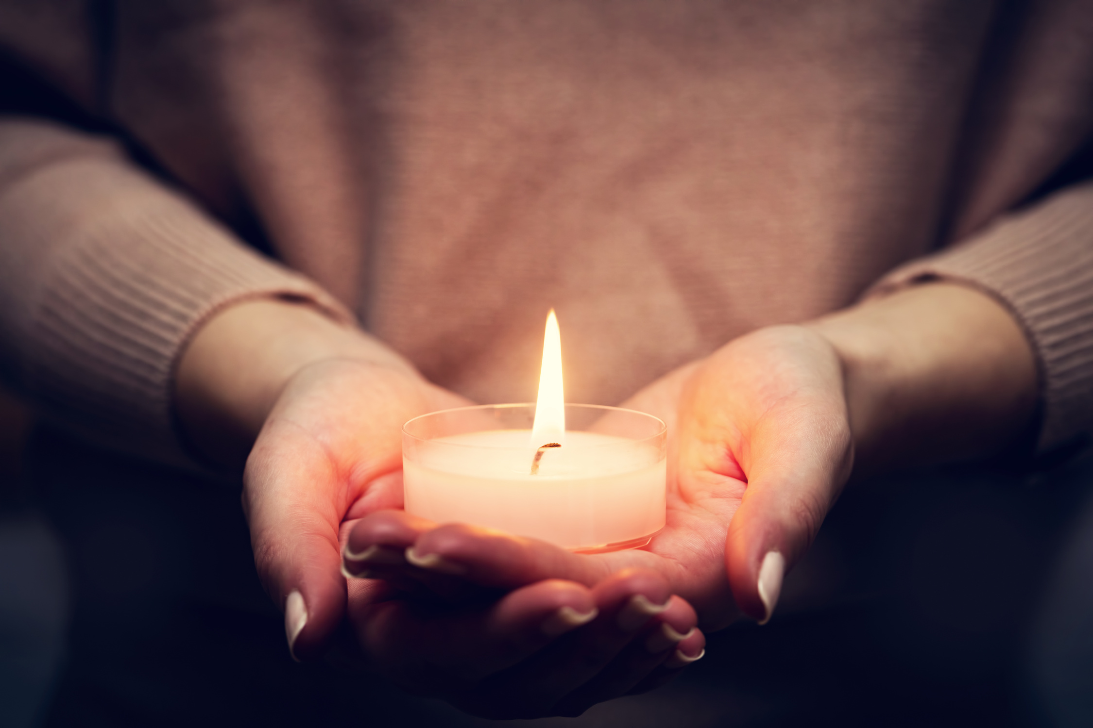Candle Light Glowing in Woman's Hands